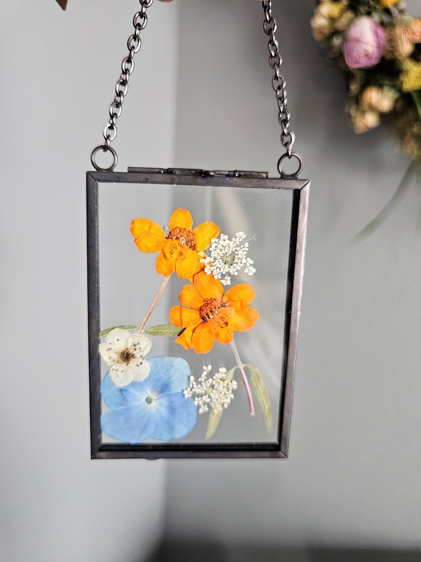 "mini" vintage style black frame with pressed blue and orange flowers