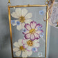 Vintage style gold frame with pressed pink, white, purple and blue flowers (cosmos and forget-me-nots)