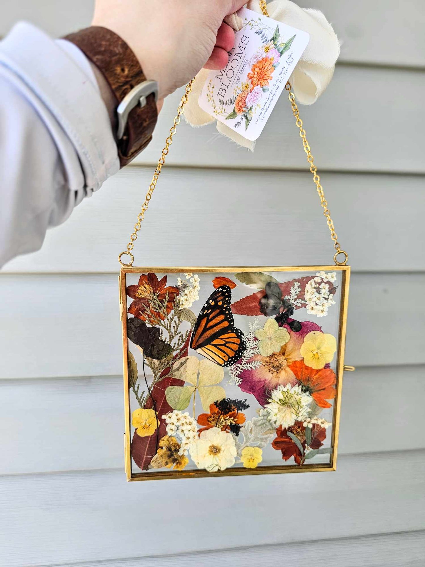 Vintage style gold square frame with pressed natural monarch wings, rust red, tan, natural and white flowers and leaves