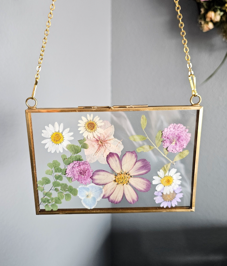 Vintage style gold frame with pressed pink, white, purple and blue flowers