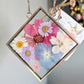 vintage style silver square frame with pressed pink, blue and purple flowers