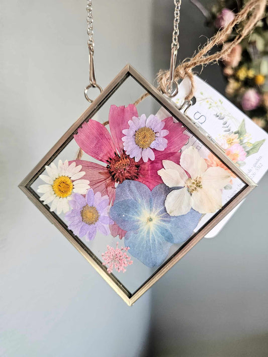 vintage style silver square frame with pressed pink, blue and purple flowers