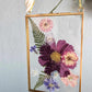 vintage style gold rectangle frame with pressed pink cosmo, blue and purple flowers + ferns